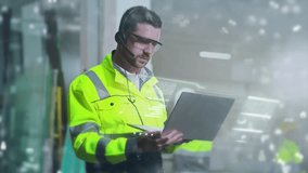 Caucasian male engineer wearing safety glasses and headset using laptop in industrial warehouse. Worker in bright reflective jacket analyzing holographic data projections. Modern logistics workspace. - Powered by Shutterstock - Get 15% off with code: PIKWIZARD15
