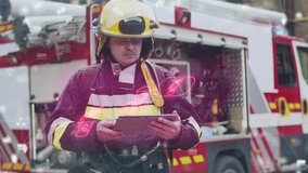 Firefighter wearing helmet and uniform standing near fire truck. Man holding tablet device with holographic data projection. Emergency worker inspecting digital report at accident scene outdoors. - Powered by Shutterstock - Get 15% off with code: PIKWIZARD15