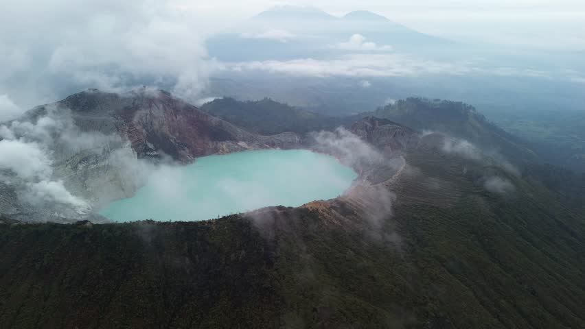Dramatic view of active volcano, smoke coming up from acidic lake. Ijen, Indonesia. Drone panoramic