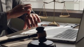 Lawyer checking time at desk with gavel, scales of justice and laptop. Concept of legal deadline, time pressure, and digital law office. - Powered by Shutterstock - Get 15% off with code: PIKWIZARD15