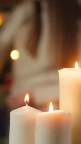 Woman decorating christmas tree. Young female student hanging balls and toys on evergreen tree in living room. Winter holidays concept, present box. Celebrating new year at home. 