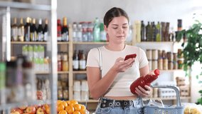 Young woman buyer scanning qr code for fresh tomato juice in bottle in grocery store - Powered by Shutterstock - Get 15% off with code: PIKWIZARD15