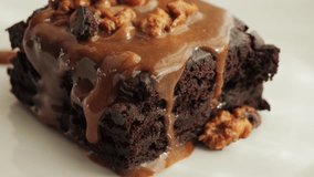 Chocolate brownies garnished with caramel and nuts. Sweet food. High quality 4k footage - Powered by Shutterstock - Get 15% off with code: PIKWIZARD15