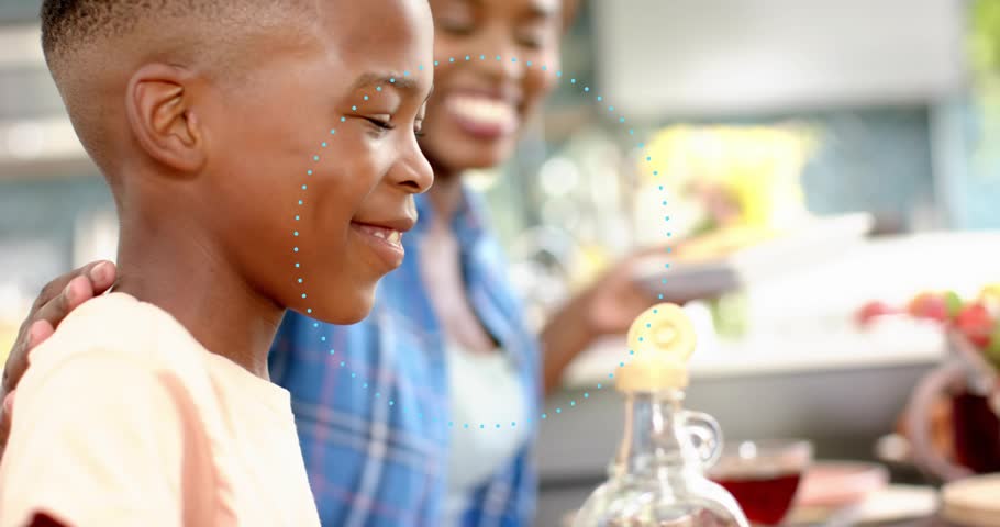 woman pouring honey in kitchen during breakfast causing boy dipping fingers into blueberry bowl. Family, breakfast, nutrition, wholesome, cozy, candid, vibrant