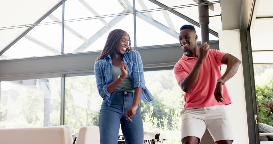 Couple performing rhythmic dance gesture invoking binary rain overlay showcasing technology theme. Romantic, modern, futuristic, upbeat, energetic, synchronized, urban