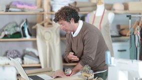 Male designer communicates with a client on a video call, he asks questions about the size and choice of fabric. Tailor gives recommendations on tailoring clothes to the client online. High quality 4k - Powered by Shutterstock - Get 15% off with code: PIKWIZARD15