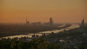 Stunning panoramic view of Vienna at sunrise. Golden-pink sky illuminates the Danube, busy bridges, and misty skyscrapers, creating a cinematic and atmospheric cityscape with early morning light. - Powered by Shutterstock - Get 15% off with code: PIKWIZARD15
