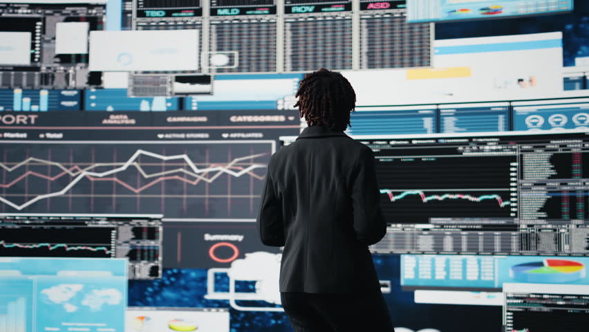 Business analyst reviewing performance dashboards and financial KPIs during corporate strategy planning session. Manager evaluating annual report data, brainstorming growth opportunities, camera A