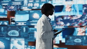 Cheerful woman showing futuristic medical visuals on digital videowall during conference. Jolly African american doctor presenting medical research data and 3D anatomy models dashboards, camera B - Powered by Shutterstock - Get 15% off with code: PIKWIZARD15