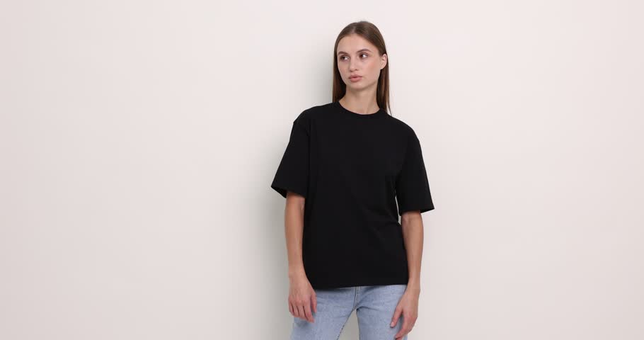 Woman wearing black t-shirt on white background. Mockup for design