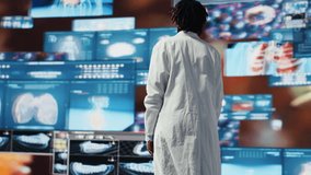 Portrait of healthcare specialist looking at CT scans, MRI data, and lab analytics displayed on videowall. Scientist in medical research lab reading health data on high tech digital panels, camera B - Powered by Shutterstock - Get 15% off with code: PIKWIZARD15