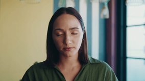 Happy businesswoman making online video call and waving at camera using earphones in office - Powered by Shutterstock - Get 15% off with code: PIKWIZARD15