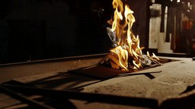 Burning wood-cardboard scraps sparking red cyan shapes pulsing fading as flames flickering on metal. Abstract, geometric, vibrant, industrial, energy, movement, modern - Powered by Shutterstock - Get 15% off with code: PIKWIZARD15