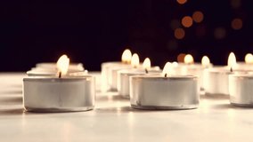 Orange-red sparkler streak descending, lifting, drawing loops over candles, forming light pattern. Light trails, glow, illumination, ambiance, artistry, decor, abstract - Powered by Shutterstock - Get 15% off with code: PIKWIZARD15