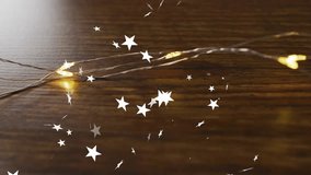 Flickering warm white fairy lights sending stars swirling upward across tabletop for festive mood. Ambient, cozy, enchantment, illumination, celebration, elegance, mystic - Powered by Shutterstock - Get 15% off with code: PIKWIZARD15