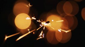 Igniting sparkler radiating sparks outward, drifting snowflake motifs evoking winter festival mood. Festivity, celebration, glow, illumination, texture, magic, night - Powered by Shutterstock - Get 15% off with code: PIKWIZARD15