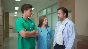 Diverse team of doctors and medical professionals from different nationalities standing in hospital corridor, discussing healthcare data and explaining information on digital tablet with teamwork. - Powered by Shutterstock - Get 15% off with code: PIKWIZARD15