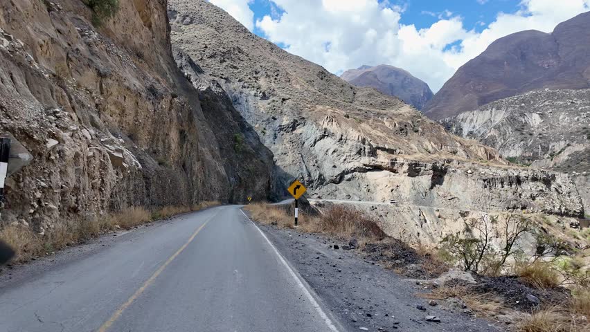 Huaraz, Peru: Point of view footage of driving on narrow road in Canyon del Pato near Huaraz, Peru. Showing the road in between two rocky mountains under sunny day