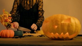 Baking preparations as chef cuts walnuts on cutting board illuminated pumpkin lantern decorates kitchen - Powered by Shutterstock - Get 15% off with code: PIKWIZARD15