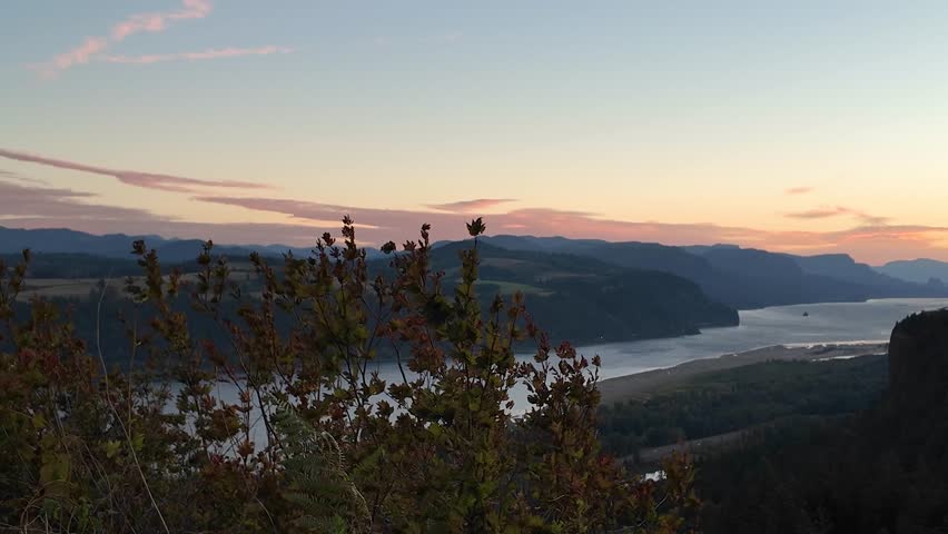 4K footage of sunrise view from Portland Women’s Forum State Scenic Viewpoint overlooking Vista House and Columbia River Gorge, Oregon, USA. Morning light, fall trees, and peaceful autumn landscape