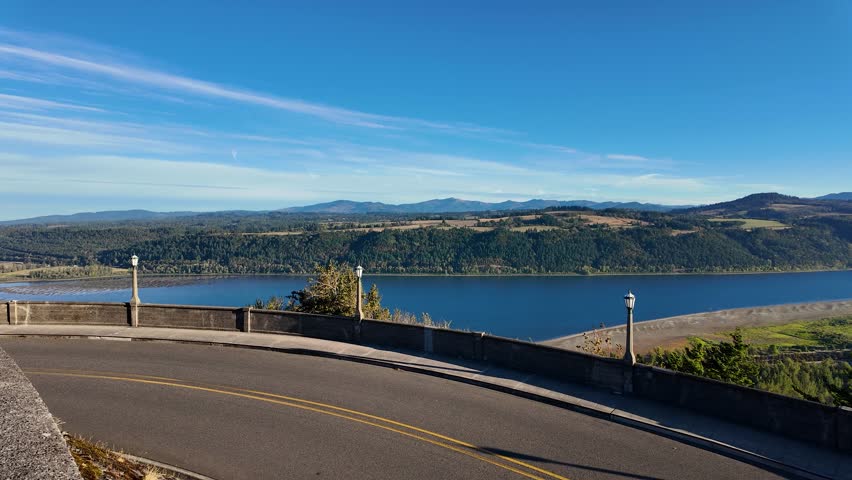 4K footage of early morning view from Vista House at Crown Point overlooking Columbia River Gorge, Oregon, USA. Scenic valley, calm river, autumn air, and clear blue sky in peaceful nature fall scene