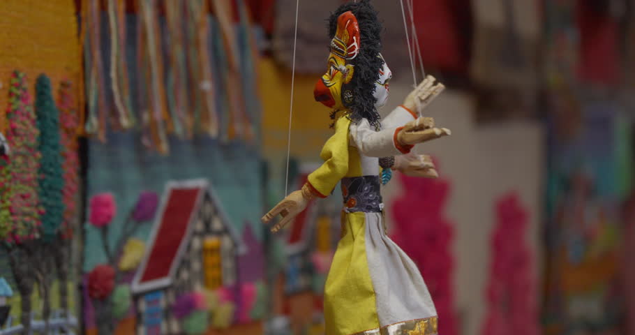 Handmade Nepali puppets hang by threads at Basantapur Durbar Square, dressed in traditional costumes. A charming symbol of Nepal’s art, culture, and heritage attracting tourists worldwide