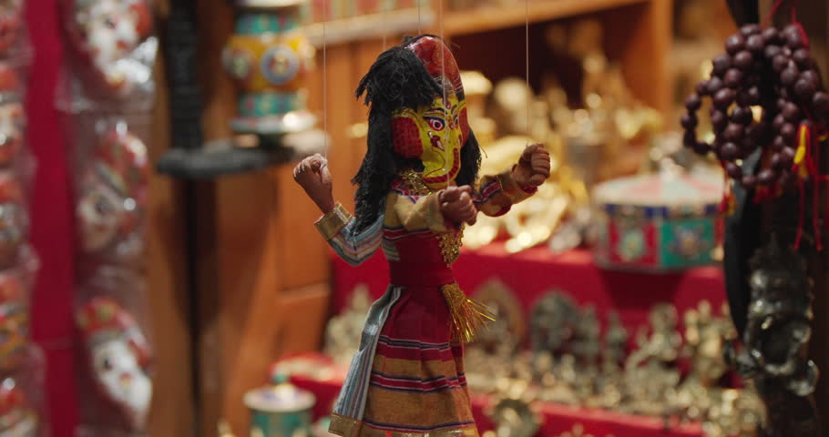 A handmade Nepali puppet dressed in traditional attire hangs at Basantapur Durbar Square, Kathmandu. A colorful symbol of Nepal’s art, culture, and craftsmanship attracting global tourists