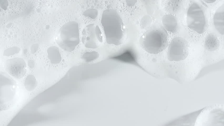 Texture of white soap foam with bubbles abstract background. Soap sud macro structure. Bathtup Soap Foam. Natural White Shampoo Bubbles Motion.