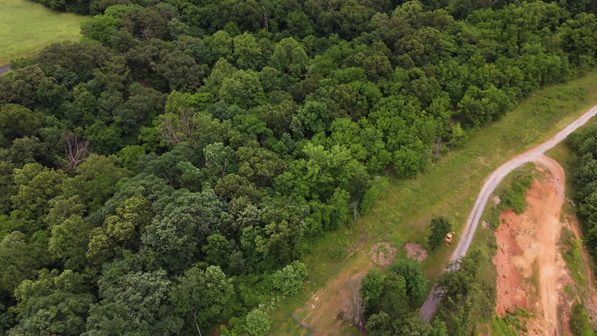 Aerial View Of Rural Landscape With Lush Green Trees And Dirt Road In Siloam Springs, Arkansas, United States - Drone Shot