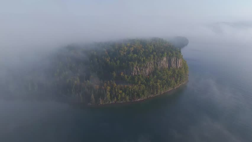 Vertical cliff and forest during early autumn at Lake Superior shoreline in Ontario, Canada. Aerial view