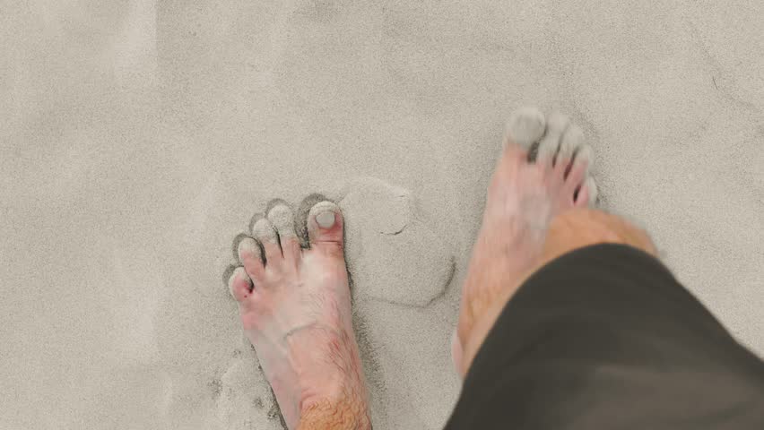 Barefoot walk on soft beach sand captured in high definition slow motion