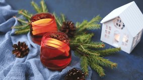Warm mulled wine with orange slices and star anise in festive winter setting with pine cones - Powered by Shutterstock - Get 15% off with code: PIKWIZARD15