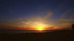 Silhouette of a woman skateboarding on the beach at sunset - Powered by Shutterstock - Get 15% off with code: PIKWIZARD15
