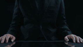 A businessman engages with a futuristic digital data display on a tablet, showcasing an analytical interface and geometric designs in a modern dark setting. Qubit - Powered by Shutterstock - Get 15% off with code: PIKWIZARD15