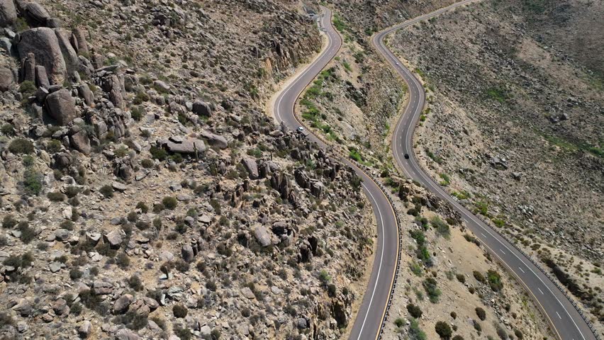 Aerial view of the stark winding road cutting through the arid, rocky landscape near the Hotshots Memorial Trailhead, Yarnell, Arizona, United States.