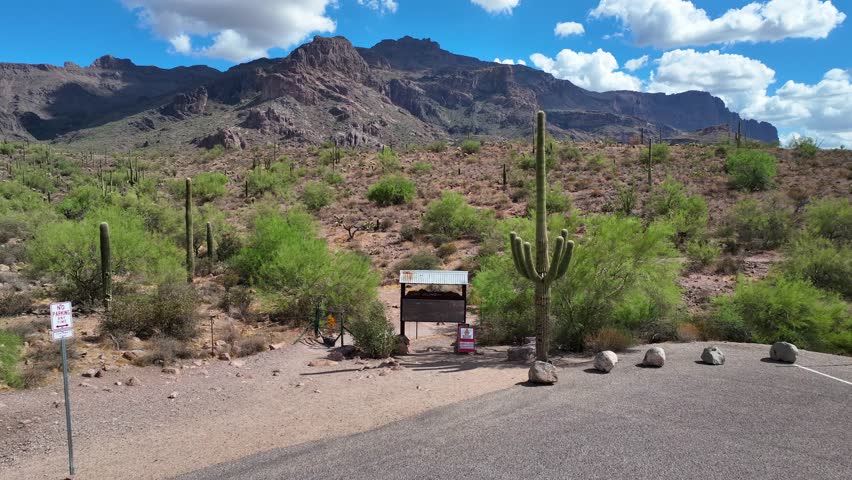Aerial view of the rugged Lost Goldmine Trail winding through the arid landscape dotted with cacti and sparse greenery, Gold Canyon, Arizona, United States.