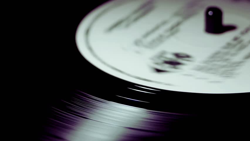 Experience the mesmerizing spin of a vintage vinyl record, evoking nostalgia and the timeless beauty of music in motion. Perfect for retro vibes and artistic flair.