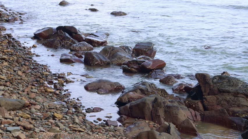 wave of the sea is hitting rocks at the bay of the sea