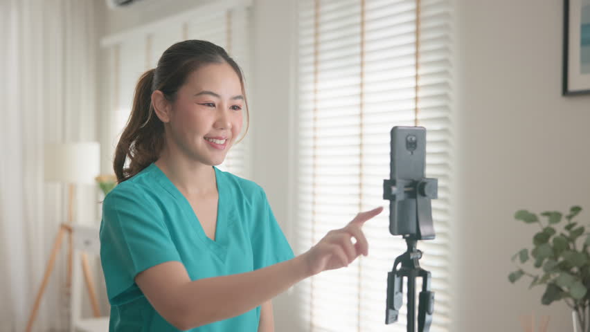 Young adult woman asia Gen Z people anti aging expert modern nurse live talk prepare video selfie camera on mobile phone app mental health care Online side hustle digital virtual asian vlogger filming