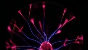 A stunning plasma globe radiates vibrant blue and pink electric arcs from its core, creating a mesmerizing and colorful display of static energy in the dark. - Powered by Shutterstock - Get 15% off with code: PIKWIZARD15