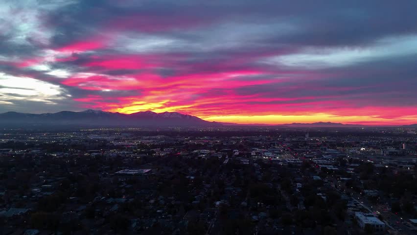 Aerial Salt Lake City skyline with mountains at sunset