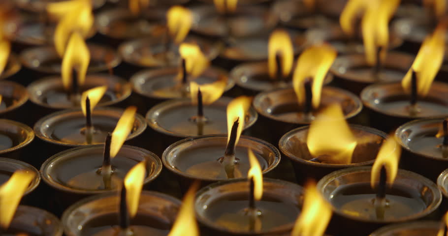 A burning butter lamp glows inside a Buddhist stupa, symbolizing peace, prayer, and hope. Its flame represents faith, purity, and the wish for a harmonious and peaceful life in Buddhism