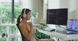 Young Asia female programmer meeting video conference discuss work prompt AI bot IT app program nomad, video game, terminal with coding, user interface, data center on desktop computer at home office. - Powered by Shutterstock - Get 15% off with code: PIKWIZARD15