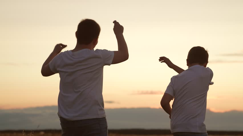 Child kid boys dancing sunset, children jumping up down, people outdoors having fun together,