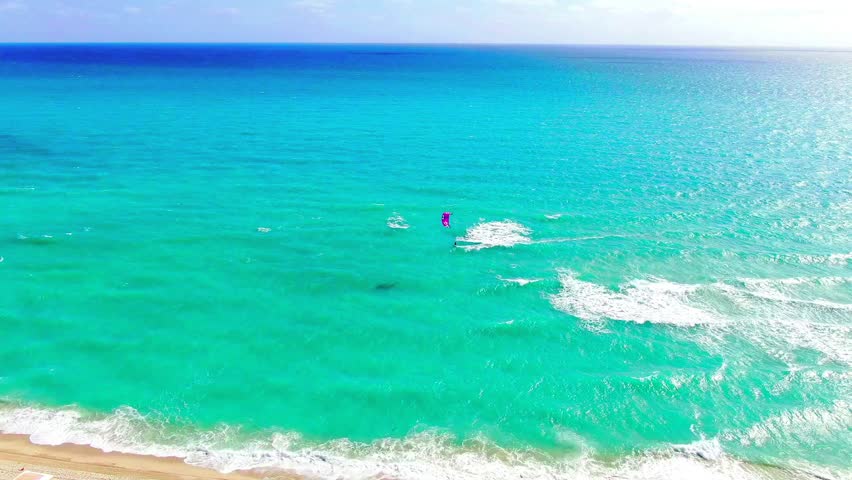 Aerial view of a kitesurfer carving waves off Miami Beach