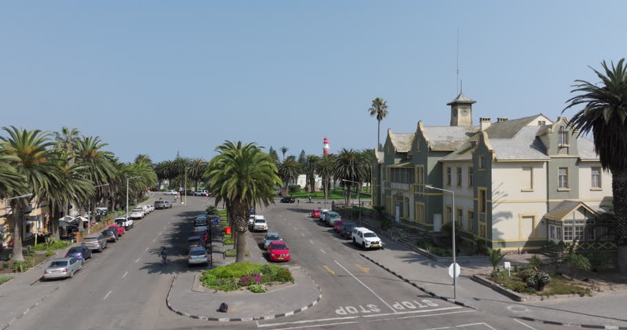 Aerial drone shot, flying over the streets of Swakopmund and the historic Swakopmund Lighthouse in Namibia. 