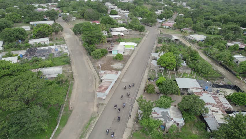 Aerial view of motorcycles on a road in rural Latin America, exploring travel