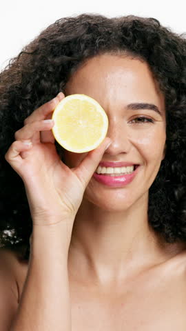 Lemon, skincare and face of woman in studio for vitamin c, treatment and cosmetics for smile. Portrait, fruit and model with diy facial, organic or skin detox with citrus cleaning on white background
