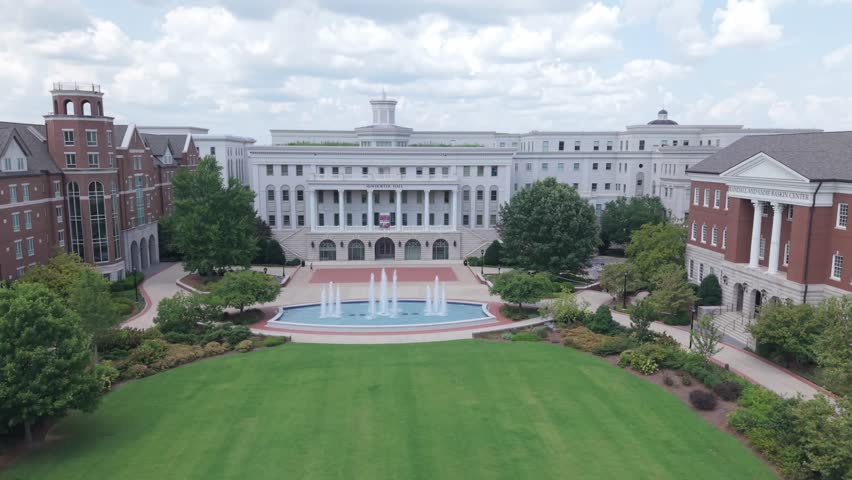 Rising Aerial Shot Of McWhorter Hall At Belmont University, Revealing Downtown Nashville City Skyline.