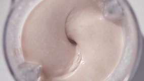 Strawberry and banana pink milkshake blended in blender with splashes. top view. slow motion. Healthy protein smoothie drink concept , food closeup - Powered by Shutterstock - Get 15% off with code: PIKWIZARD15